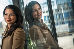 Alison Shapira Leaning Against Window With Reflection Public Speaking Tips Unexpected Year