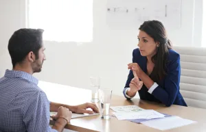 Picture of two business people speaking and engaging with one another.