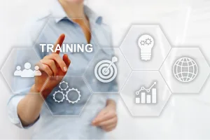 A senior leader pointing to the word training on a virtual screen of tools used to develop young leaders.