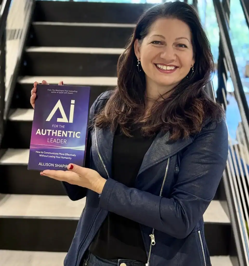 Allison Shapira holding her book AI for the Authentic Leader — executive communication expert and keynote speaker on authentic leadership, human-centered AI, and leadership presence.