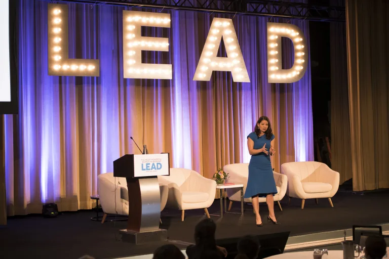 Allison Shapira speaking on stage at a leadership event, emphasizing the power of your leadership voice in 2026