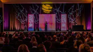 Executive advisor and keynote speaker Allison Shapira speaking on stage to a large audience about leadership communication and executive presence.