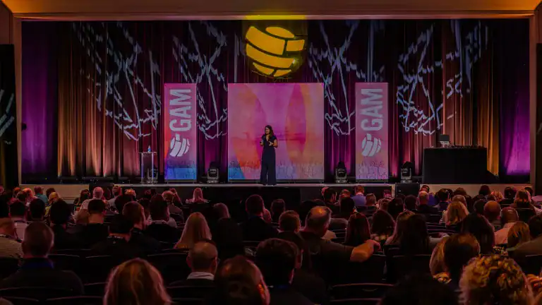 Executive advisor and keynote speaker Allison Shapira speaking on stage to a large audience about leadership communication and executive presence.
